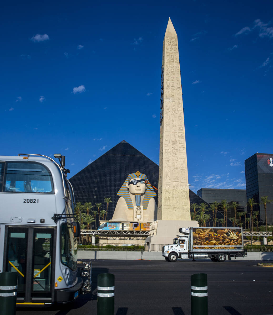 A team from Access Solutions hangs a Raiders eye patch on the Great Sphinx of Giza replica outs ...