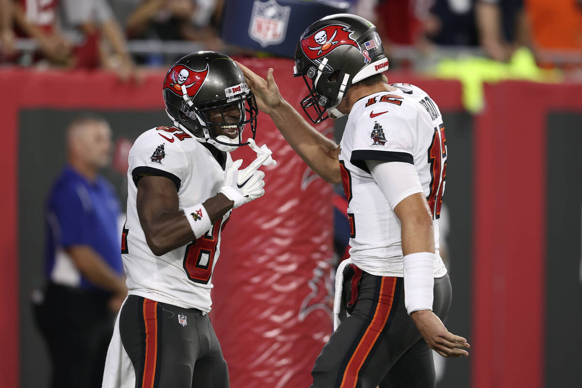 Tampa Bay Buccaneers quarterback Tom Brady (12) celebrates with wide receiver Antonio Brown (81 ...