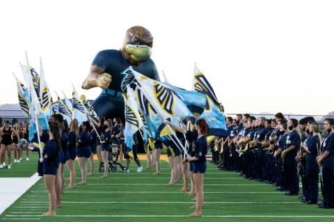 Foothill High's cheerleaders and members of the marching band lined up to welcome their players ...
