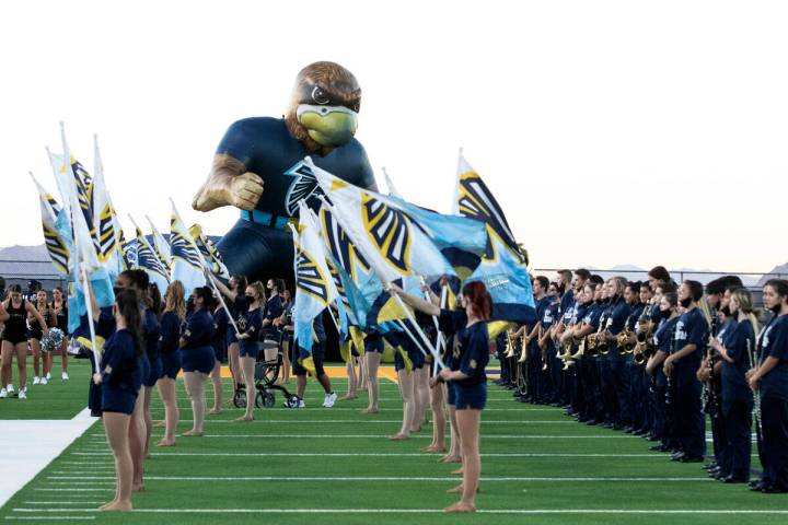 Foothill High's cheerleaders and members of the marching band lined up to welcome their players ...