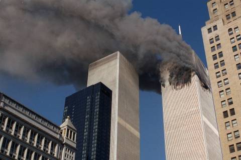Smoke pours from one of the towers of the World Trade Center Tuesday, September 11, 2001, after ...