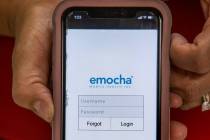 Clark County Education Association President Marie Neisess shows the emocha app on her phone in ...