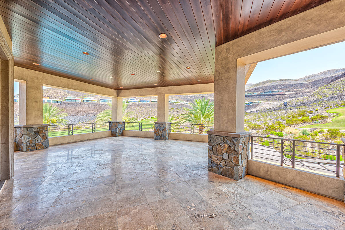 BHHS This MacDonald Highlands mansion features a wraparound covered balcony with views of the d ...