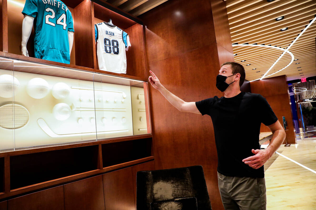 Kevin Jones, CEO of Blue Wire, points out jerseys on display at the Blue Wire Studios at Wynn L ...