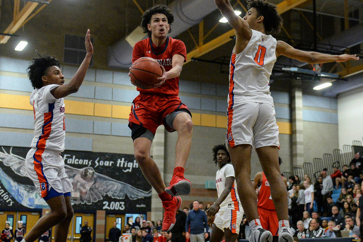 Coronado's Richard Isaacs (2) jumps up to take a shot while being guarded by Bishop Gorman's Za ...