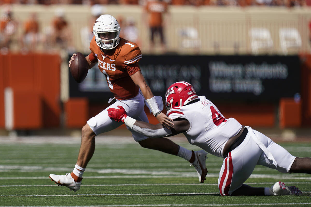 Texas quarterback Hudson Card (1) runs past Louisiana-Lafayette defensive lineman Zi'Yon Hill ( ...