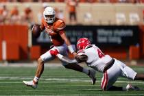 Texas quarterback Hudson Card (1) runs past Louisiana-Lafayette defensive lineman Zi'Yon Hill ( ...