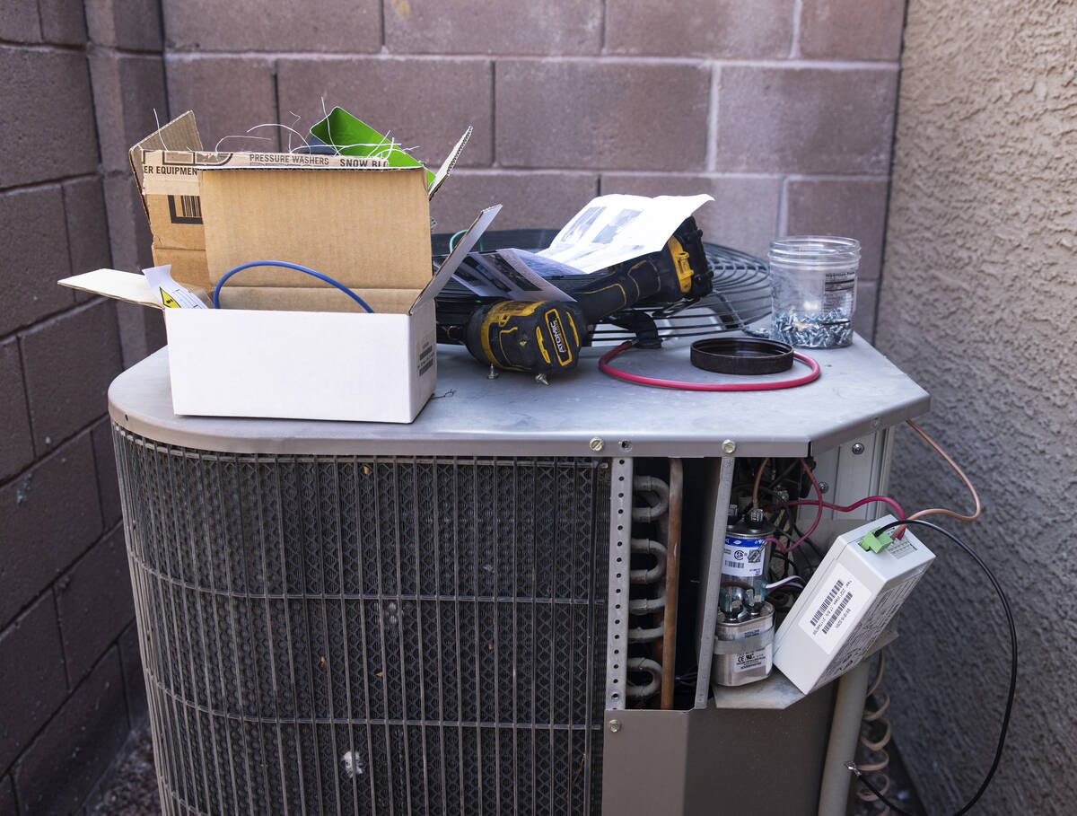 An air conditioner is under repair at Vulcan St on Friday, Sept. 10, 2021, in Henderson. (Bizua ...
