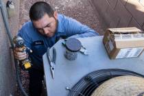 Windy City Air's technician Thomas Padron repairs an air conditioner at Vulcan St, on Friday, S ...