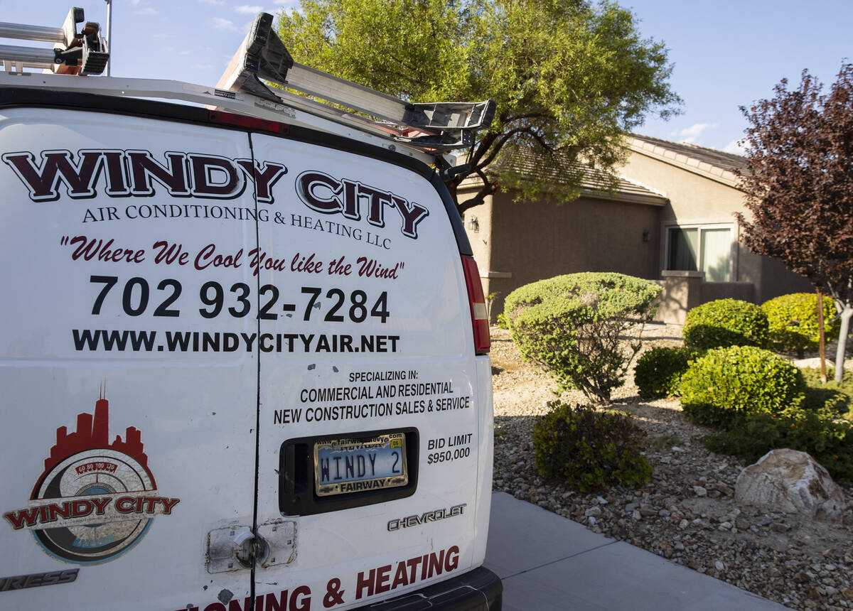 A Windy City Air's van is parked outside a house where Thomas Padron, a technician, repairs an ...