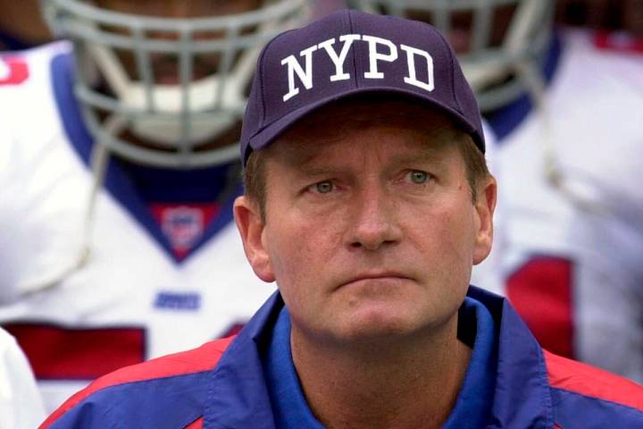 In this Sept. 23, 2001, file photo, New York Giants coach Jim Fassel wears a New York Police D ...