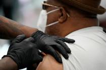 A man receives a COVID-19 vaccine in North Las Vegas in February 2021. (AP Photo/John Locher)