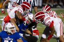 Liberty quarterback Jayden Maiava (1) sacked by Mater Dei defensive end Michael Alvarez (57) an ...