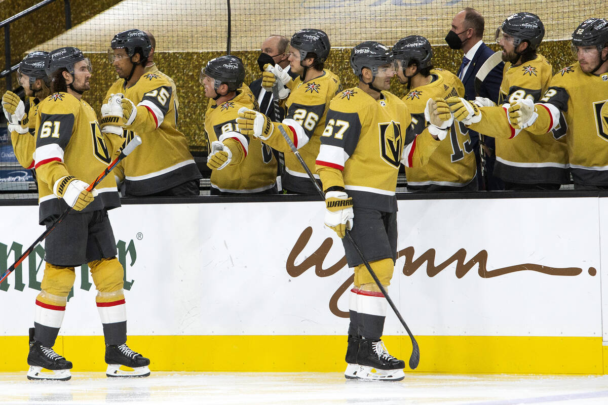 Golden Knights left wing Max Pacioretty (67) and Golden Knights right wing Mark Stone (61) fist ...