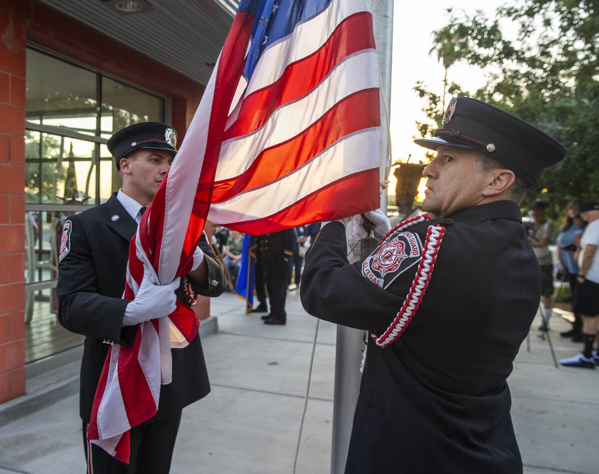 Brian Dietz, left, and Joseph Digaetano with the Las Vegas Fire Department honor guard lower th ...