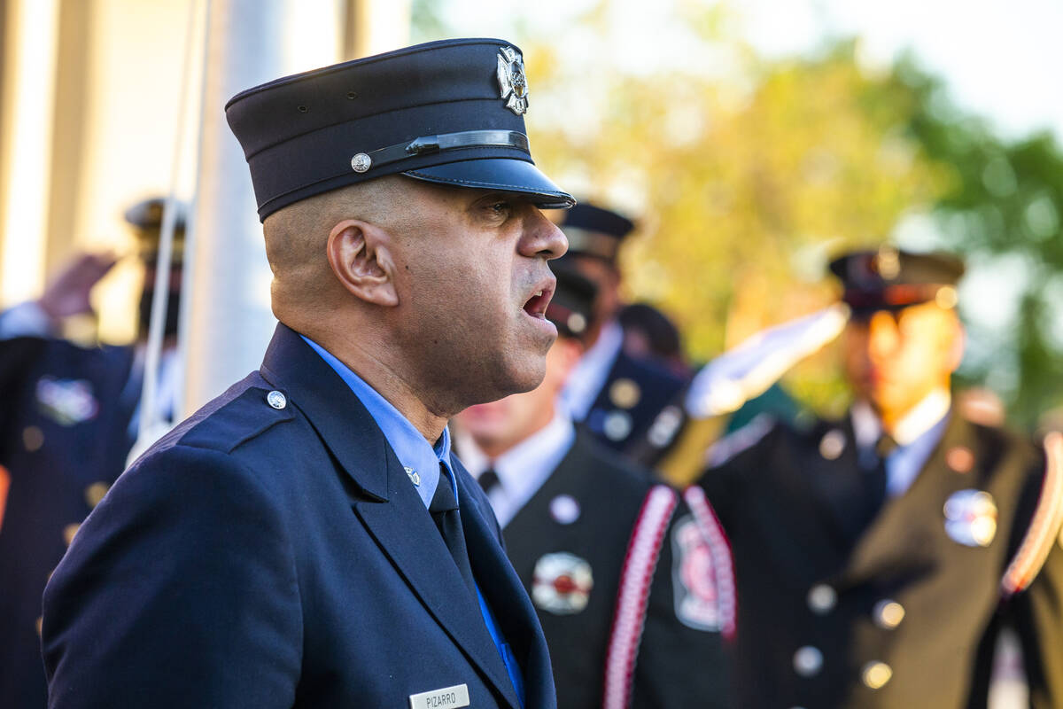 Retired New York City firefighter Frank Pizarro sings the national anthem, Saturday, Sept. 11, ...
