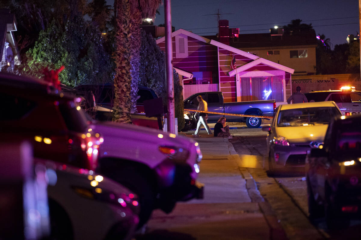 Las Vegas police officers investigate the scene of homicide on Montcliff Avenue in Spring Valle ...