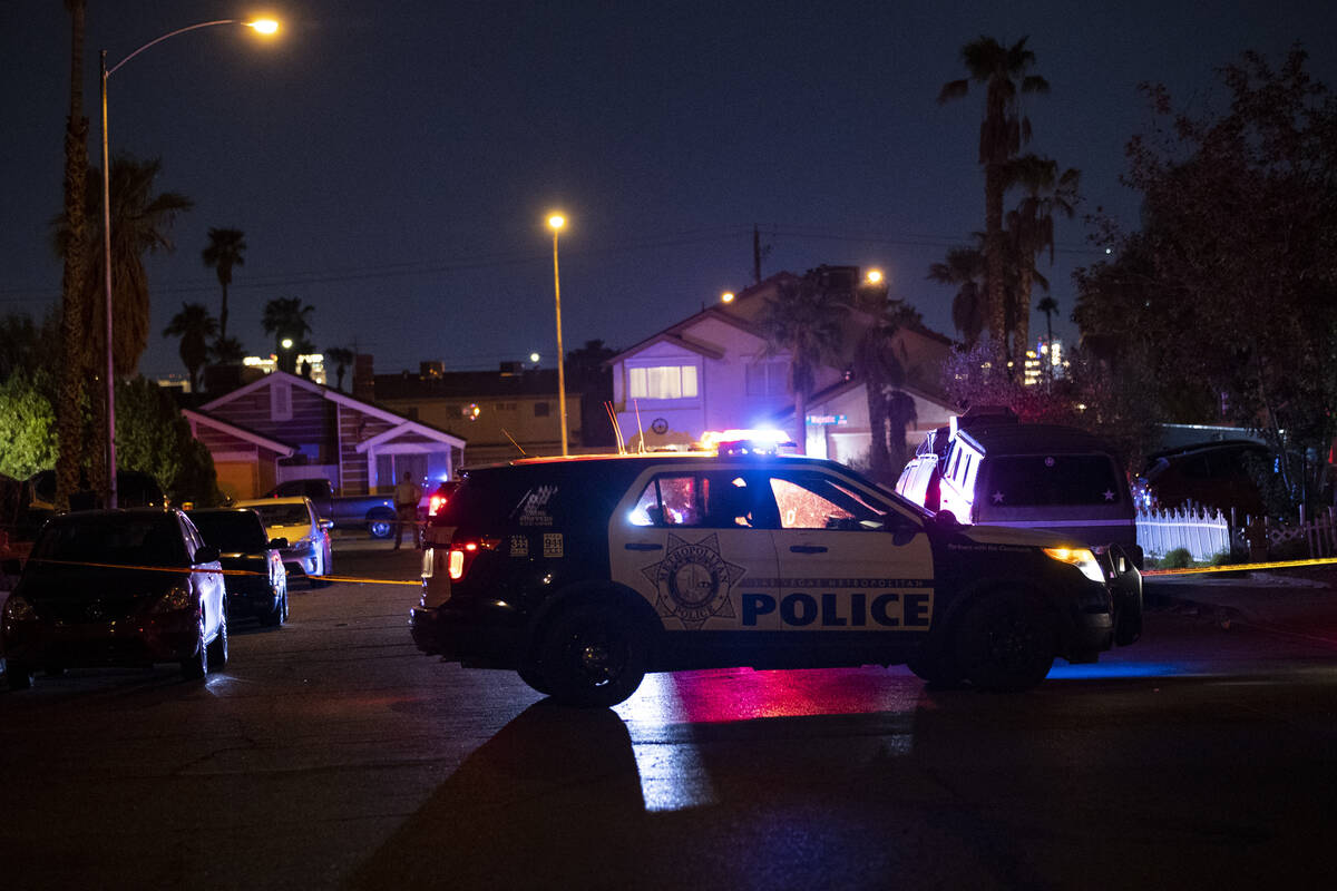 Las Vegas police officers investigate the scene of homicide on Montcliff Avenue in Spring Valle ...