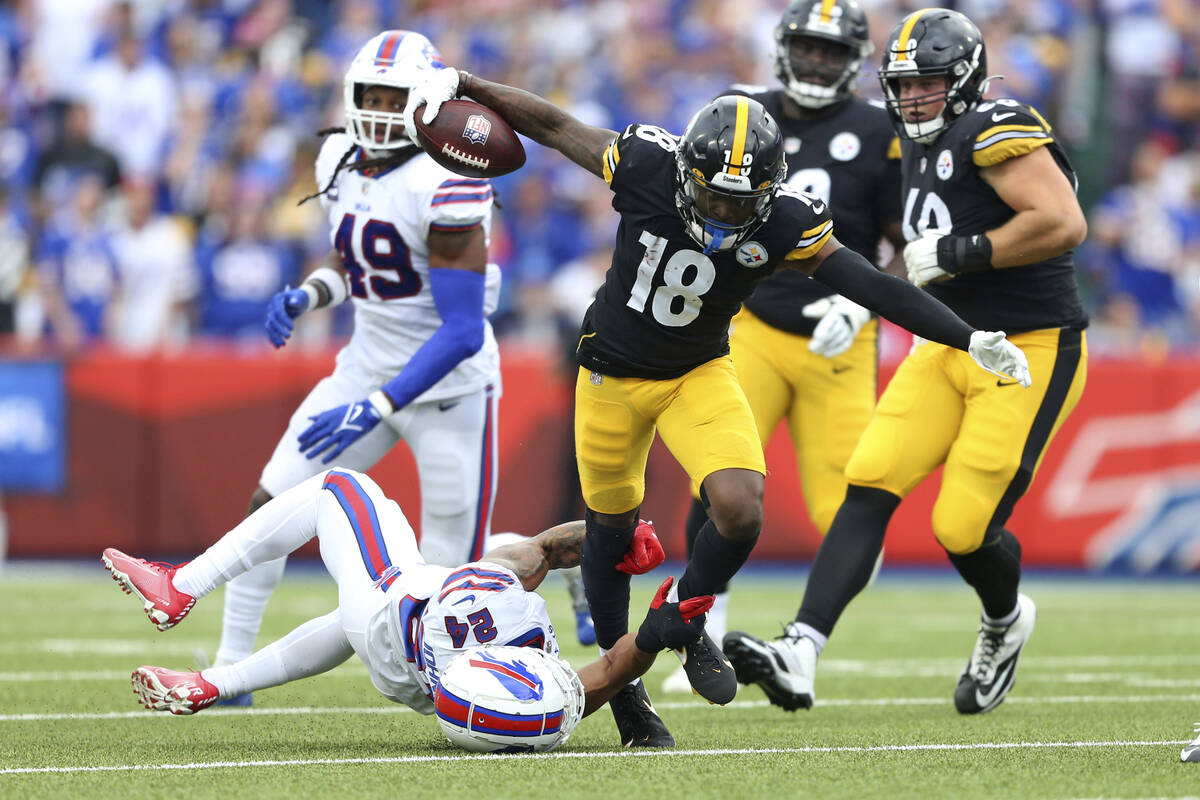 Pittsburgh Steelers wide receiver Diontae Johnson (18) is tackled by Buffalo Bills cornerback T ...