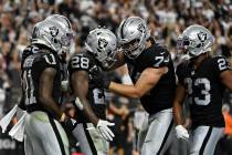 Las Vegas Raiders offensive tackle Kolton Miller (74) embraces Las Vegas Raiders running back J ...