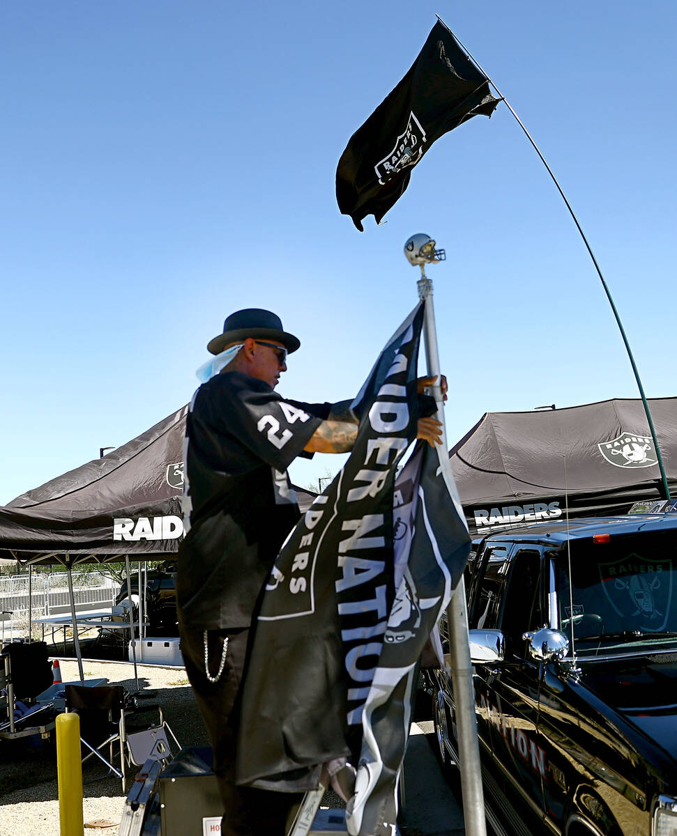 A man called himself Cadillac Ruiz of North Las Vegas prepares for tailgating before an NFL foo ...