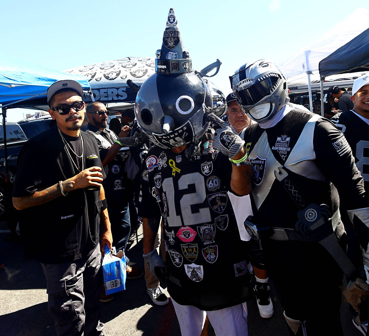 Fans spend time tailgating before an NFL football game between the Raiders and the Baltimore Ra ...