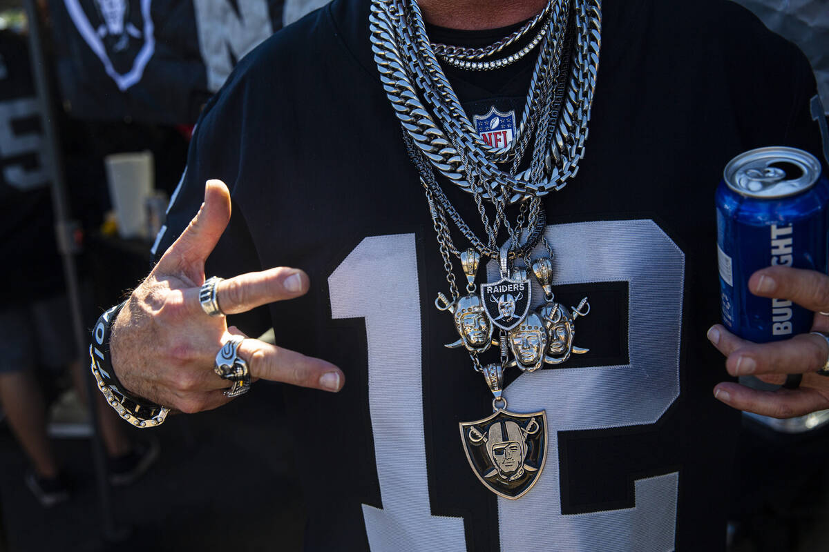 A Raiders fan shows off his chains during a tailgate before an NFL game between the Raiders and ...