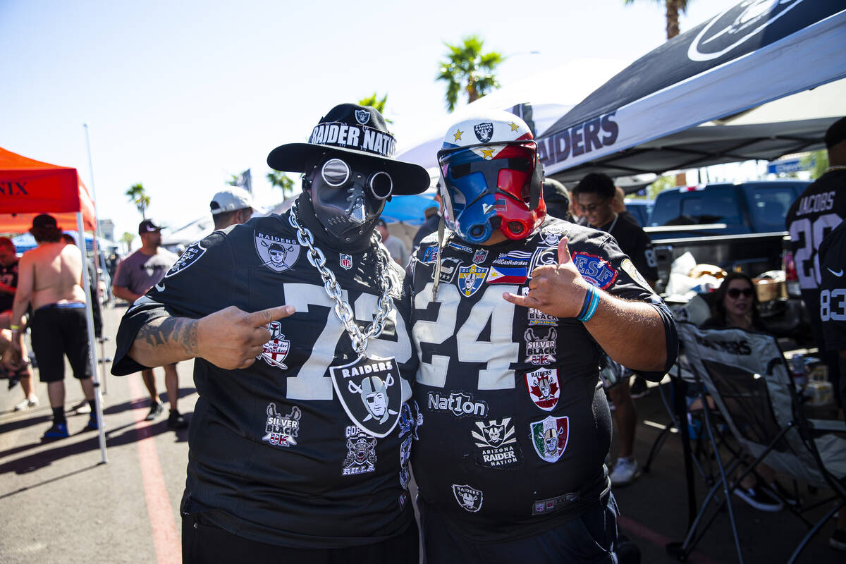 Raiders fans Phillip Prieto, left, and Gene Biyok pose for a portrait during a tailgate before ...