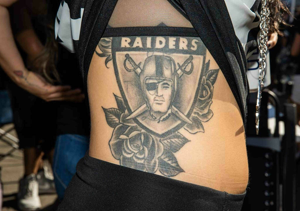 Dana Oswalt, of Las Vegas, shows off her tattoo before an NFL football game between the Raiders ...