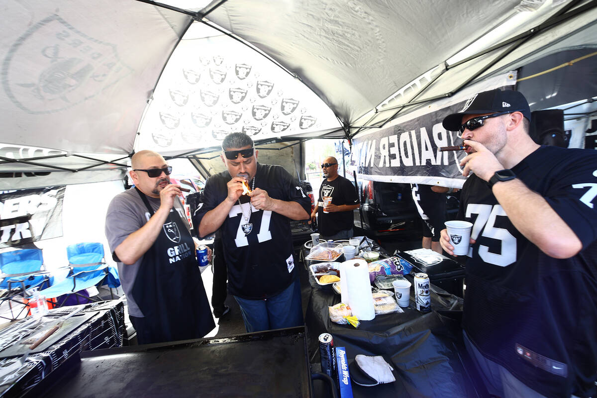 Raiders fans light cigars ahead of the team's game against the Baltimore Ravens on Monday, Sept ...