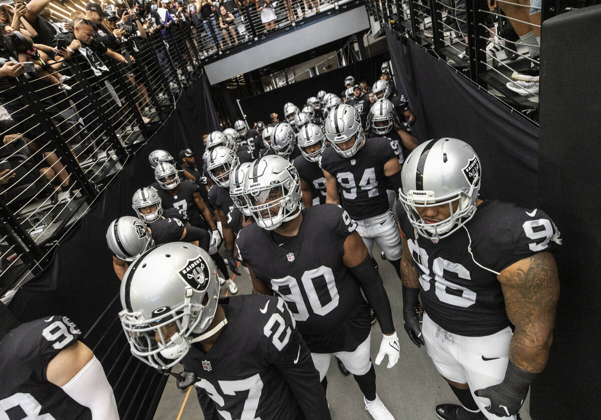 The Raiders wait to take the field before the start of an NFL football game against the Baltimo ...