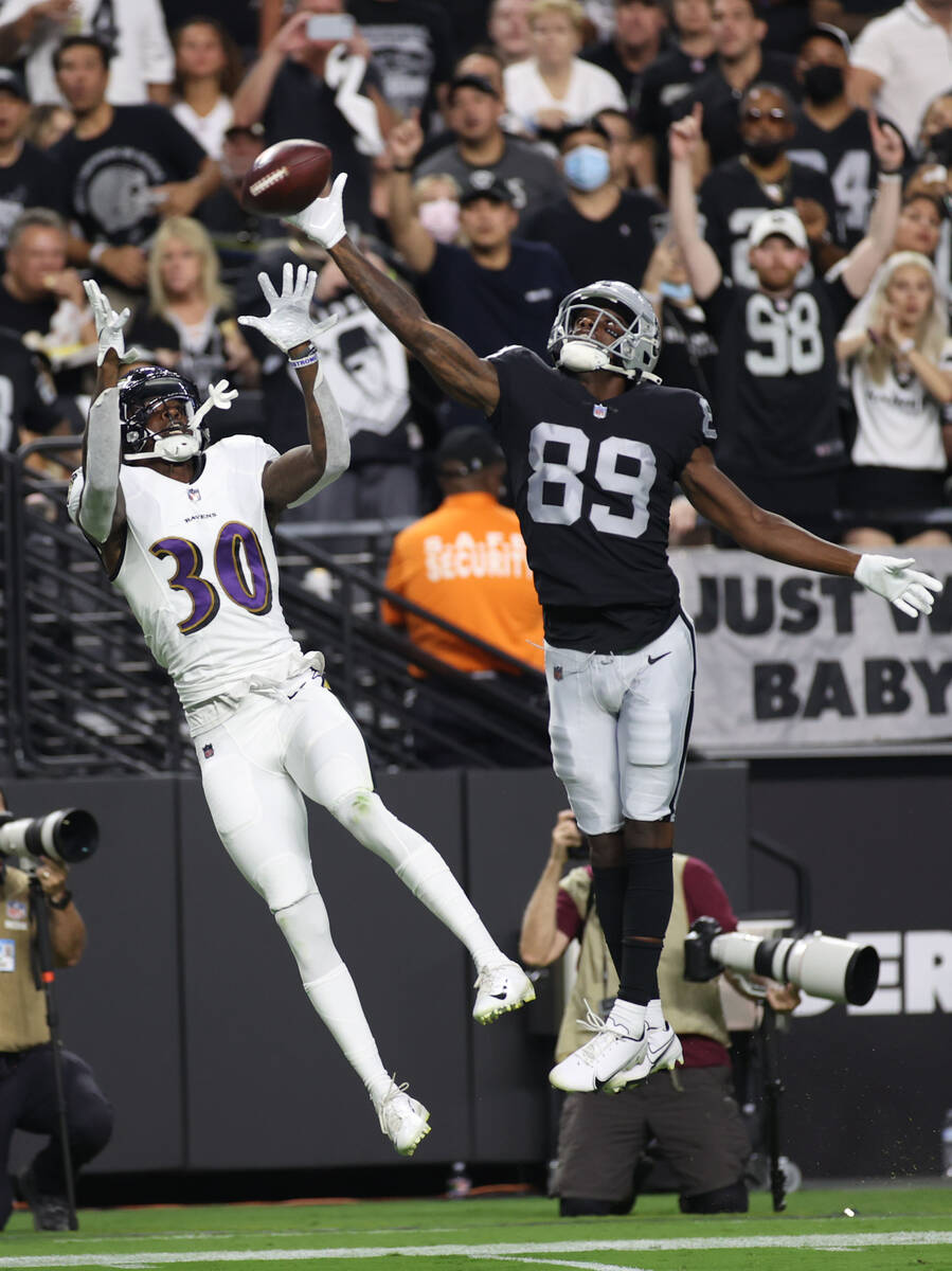 Raiders wide receiver Bryan Edwards (89) tires to catch a ball against Baltimore Ravens cornerb ...