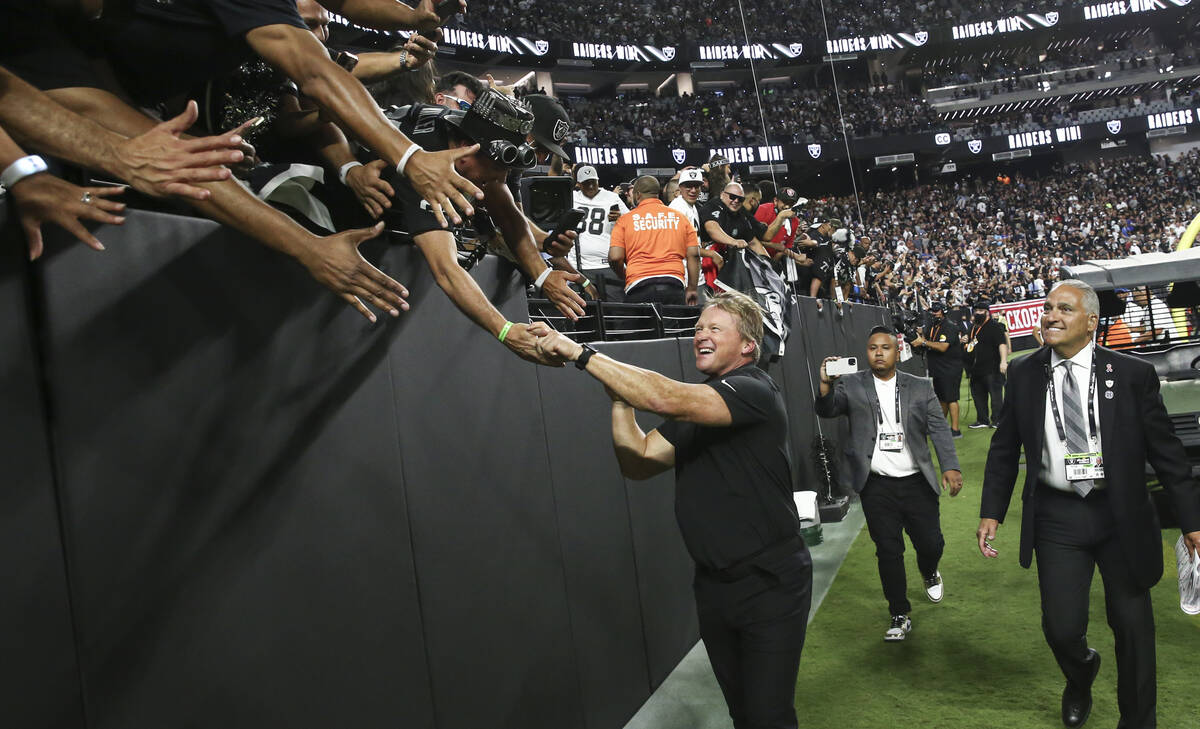 Raiders head coach Jon Gruden celebrates with fans after an overtime win against the Baltimore ...