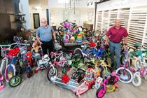 Chet Buchanan, left, 98.5 KLUC DJ whose annual Toy Drive to benefit HELP of Southern Nevada is ...