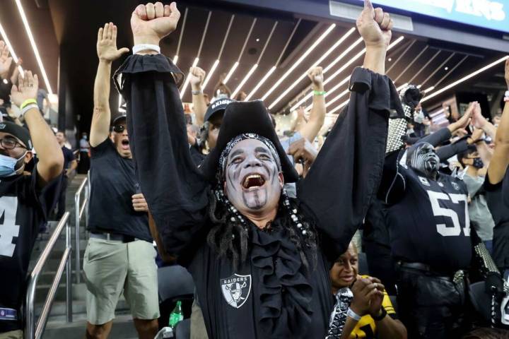 Raiders fans celebrate their overtime win in the season-opener against the Baltimore Ravens at ...