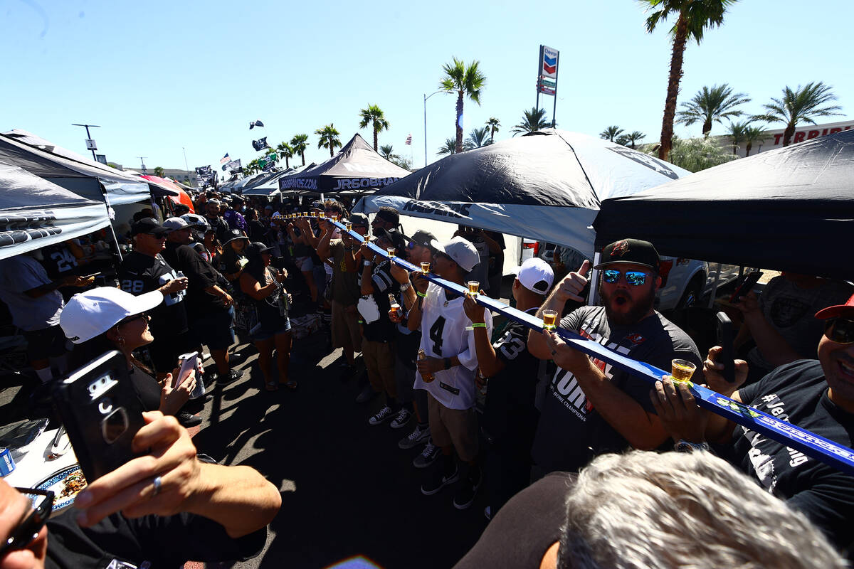 Raiders fans fire up cigars ahead of the team's game against the Baltimore Ravens on Monday, Se ...