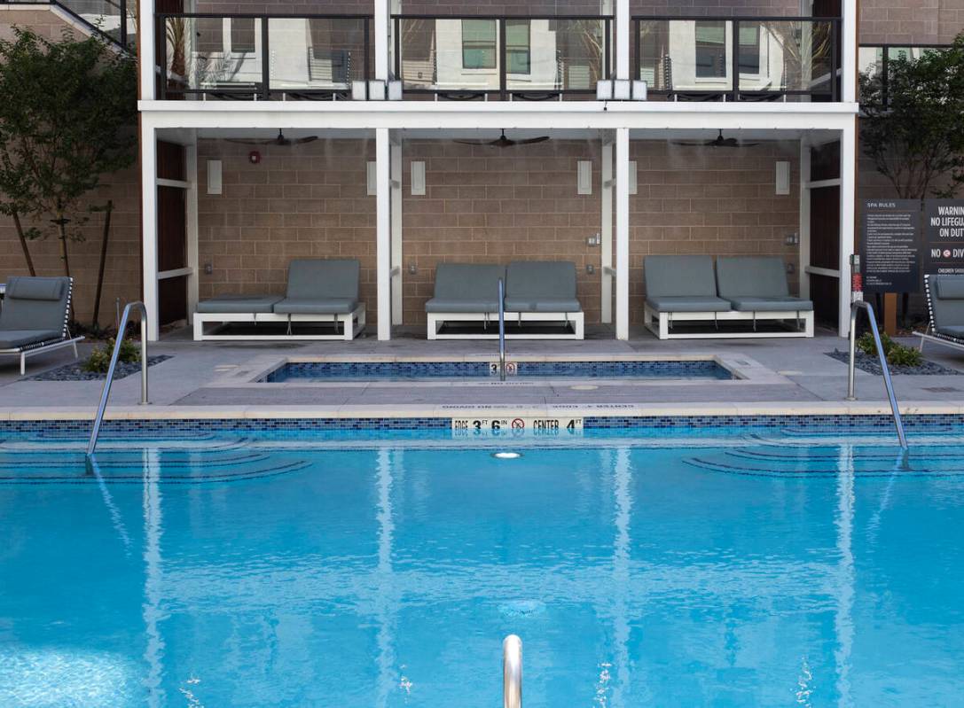 Swimming pool area at Auric Symphony Park, the first luxury multifamily residential community a ...