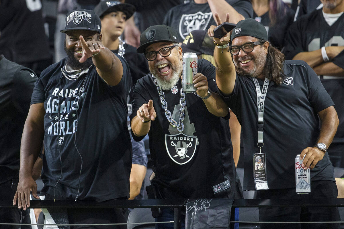 Raiders fans cheer during the first quarter of an NFL football game against the Baltimore Raven ...