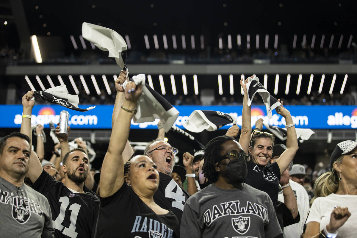Raiders fans cheer for Las Vegas during an NFL football game against the Baltimore Ravens at Al ...