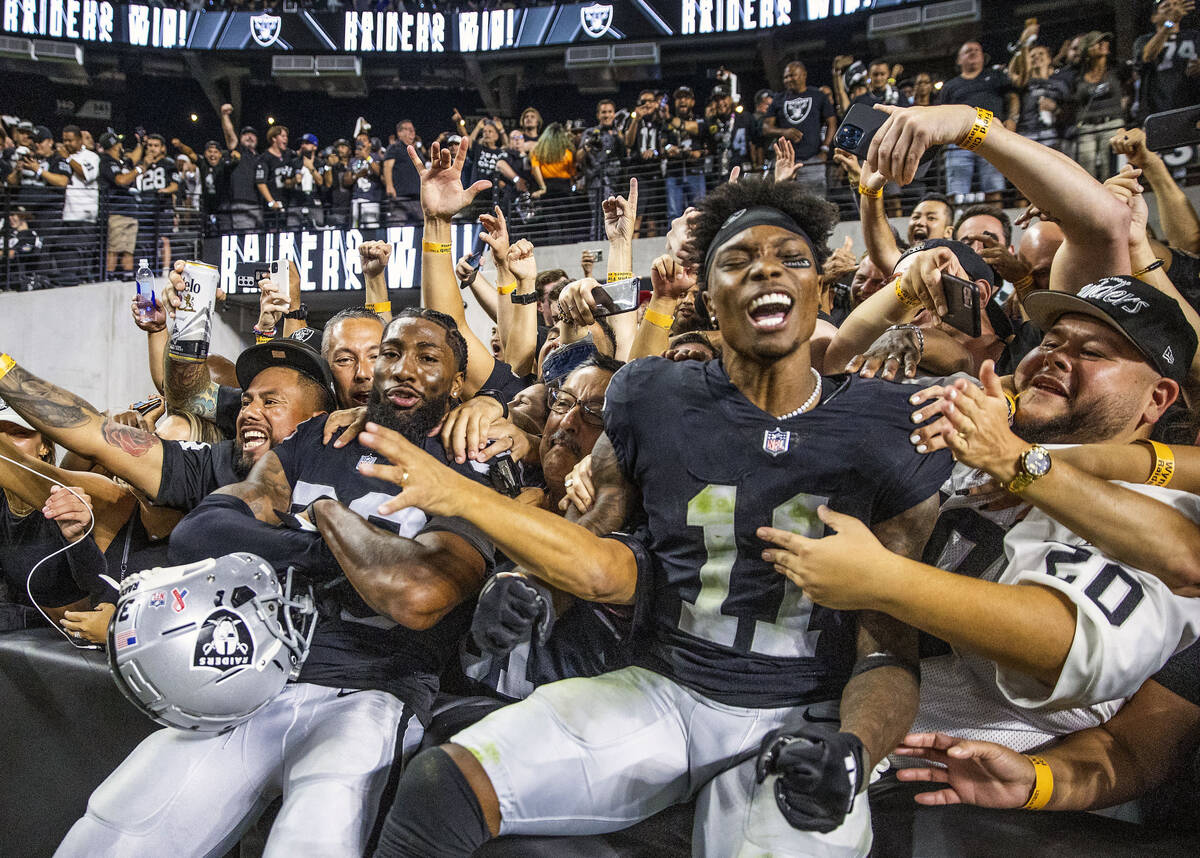 Raiders cornerback Nate Hobbs (39) and teammate Raiders wide receiver Henry Ruggs III (11) cele ...