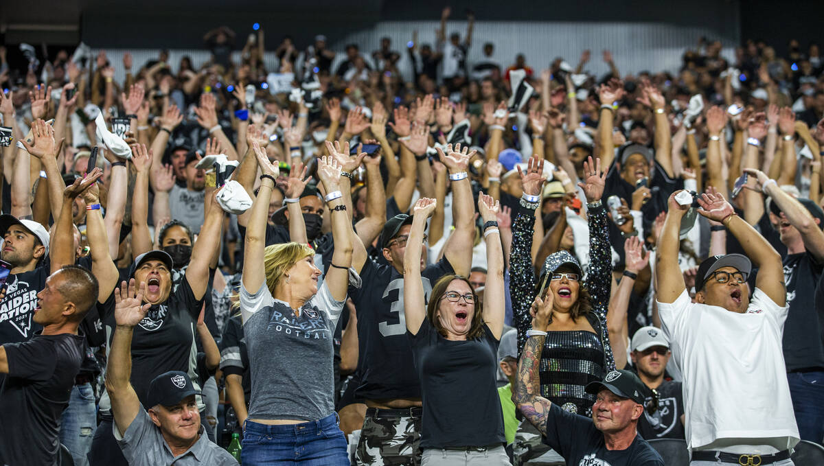 Raiders fans get excited during the fourth quarter of the Raiders' season-opener against the Ba ...