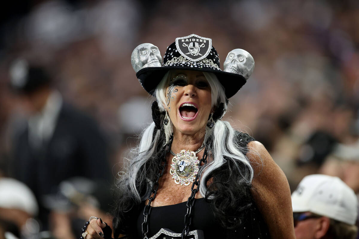 A Raiders fan cheers during the first quarter of an NFL football game at Allegiant Stadium, Mon ...