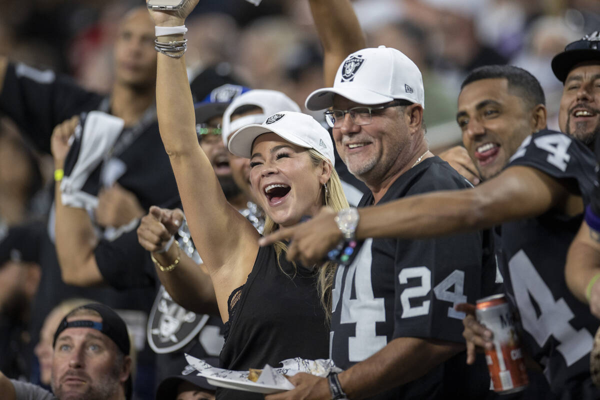 Raiders fans cheer during an NFL football game between the Raiders and Baltimore Ravens at Alle ...