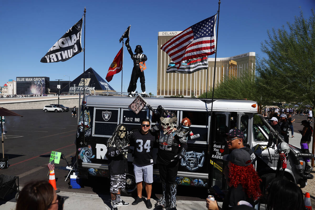 Oscar Reynoso, center, os Los Angeles, poses for a photos outside of Allegiant Stadium before t ...
