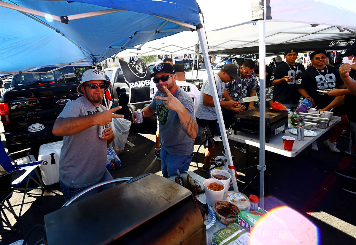 Fans spend time tailgating before an NFL football game between the Raiders and the Baltimore Ra ...