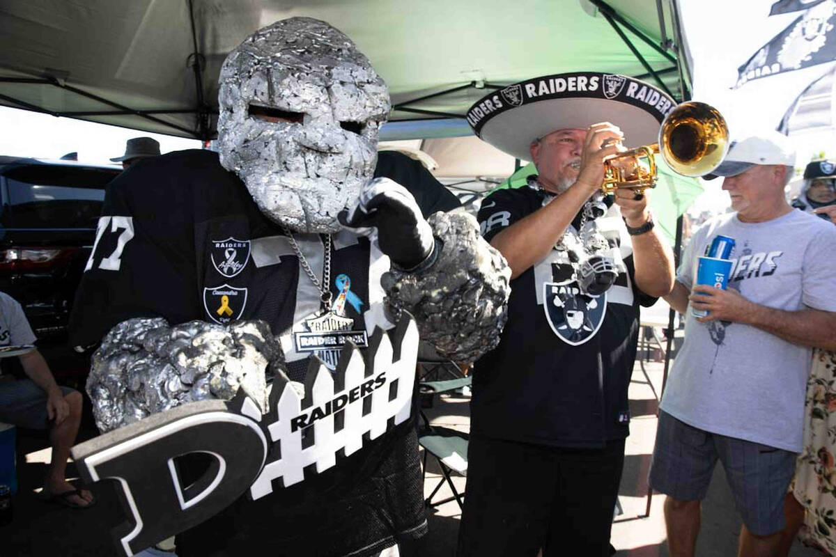 Raiders Rock, left, and Tony Valdivia tailgate before an NFL football game between the Raiders ...