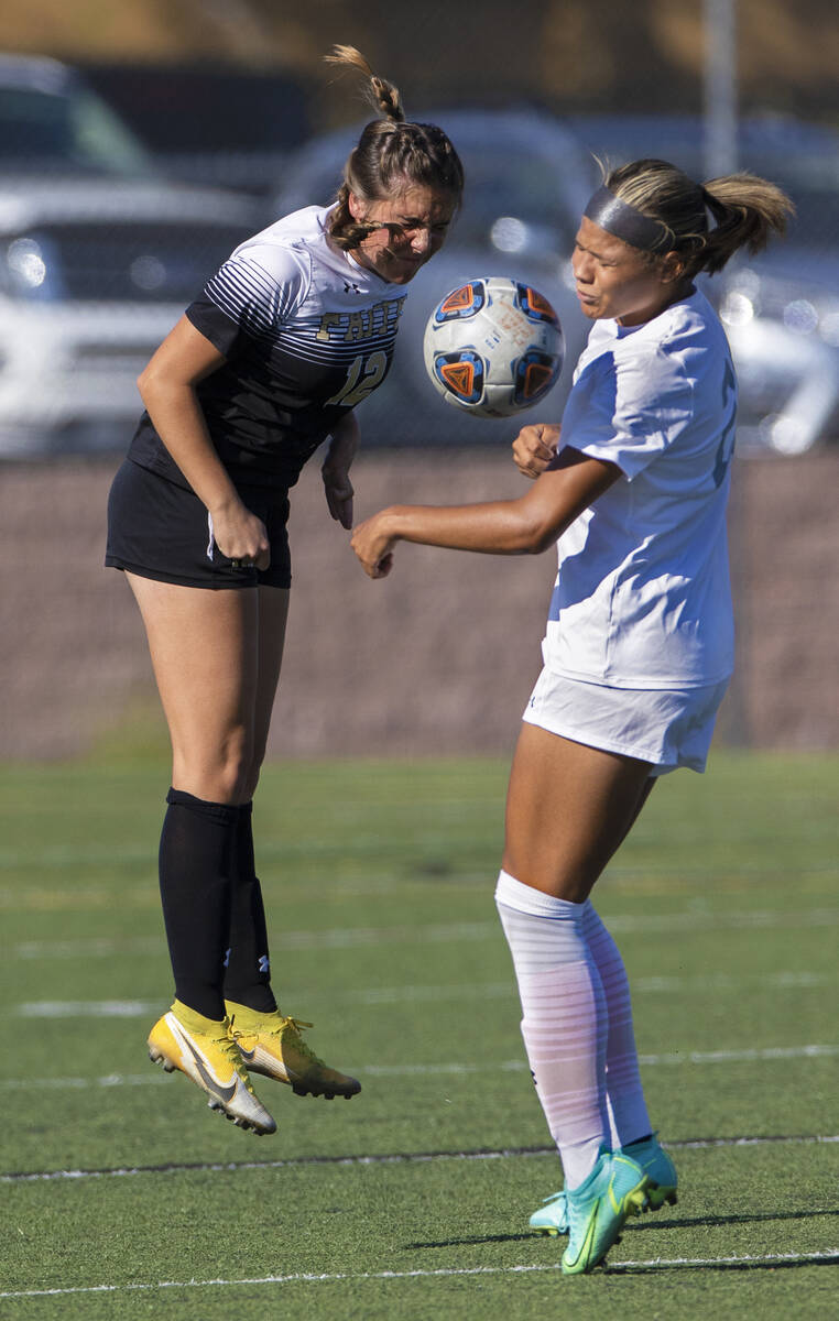 Arbor View’s Tiana Beavers (23) and Faith Lutheran’s Lindley Amick (12) fight for ...
