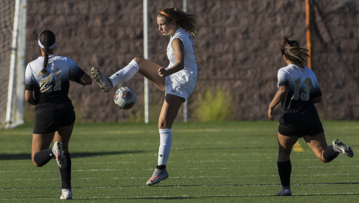 Arbor View’s Brynn Covington (20) fights for possession with Faith Lutheran’s Mia ...