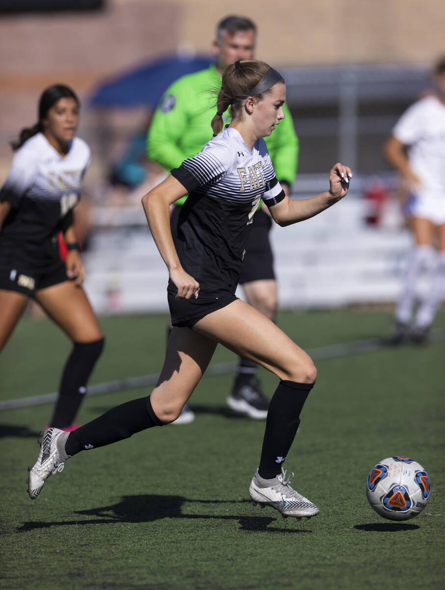 Faith Lutheran’s Taylor Day (2) moves the ball up field during a girls high school socce ...