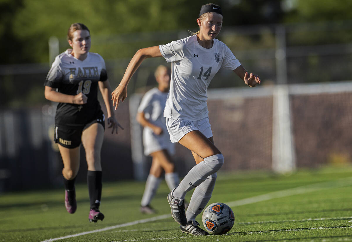 Arbor View’s Madison Little (14) pushes the ball up field past Faith Lutheran’s C ...